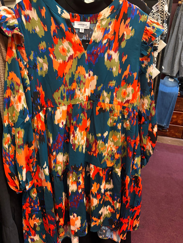 V-neck tiered mini dress by Anniewear featuring flowing fabric and a stylish layered design, perfect for casual or semi-formal occasions.