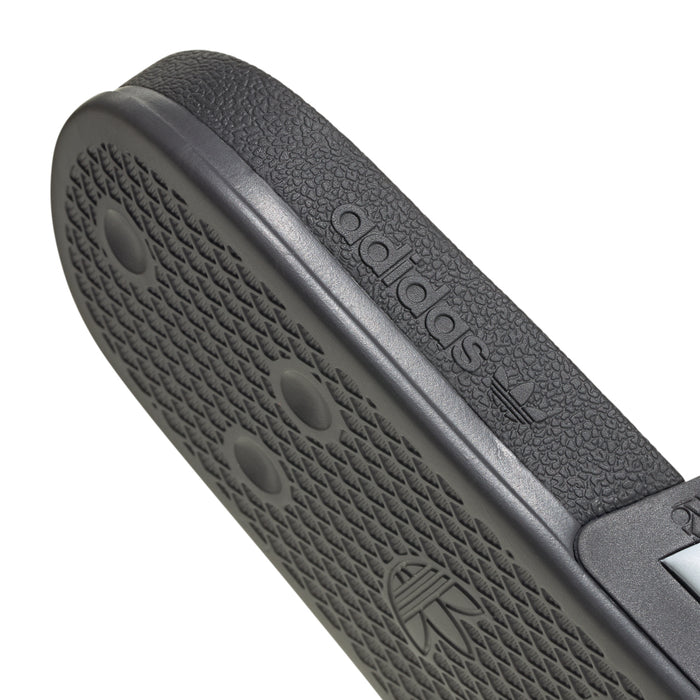 Black footbed and sole with embossed texture and Adidas logo