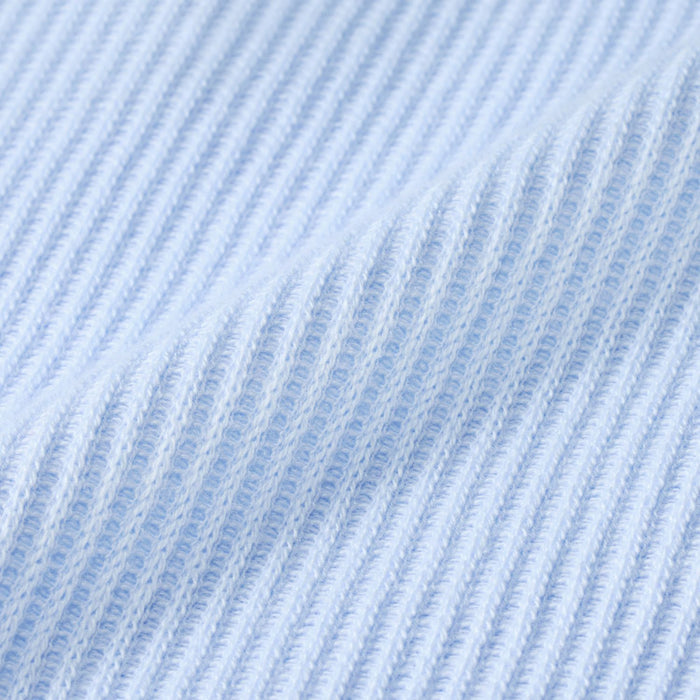 Light blue knit waffle-style texture fabric close-up with fine vertical ribbing