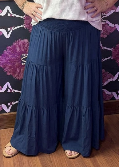 Camille & Co. tiered rayon pants with wide-leg design and flowing fabric, shown in a full-length view.