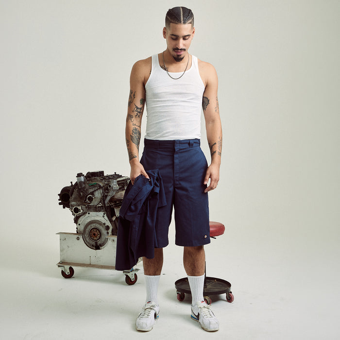 Men's dark navy loose-fit shorts worn above the knee with belt loops