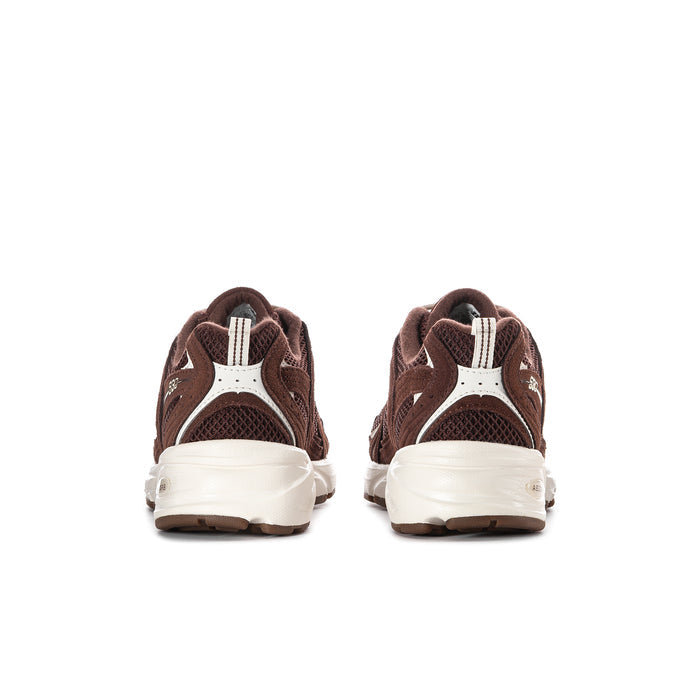 Women’s dark brown sneaker with heel tab and white stripe detail, white midsole.