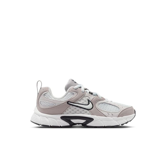 Kids lace-up sneakers in off-white and light gray with black Nike swoosh detail