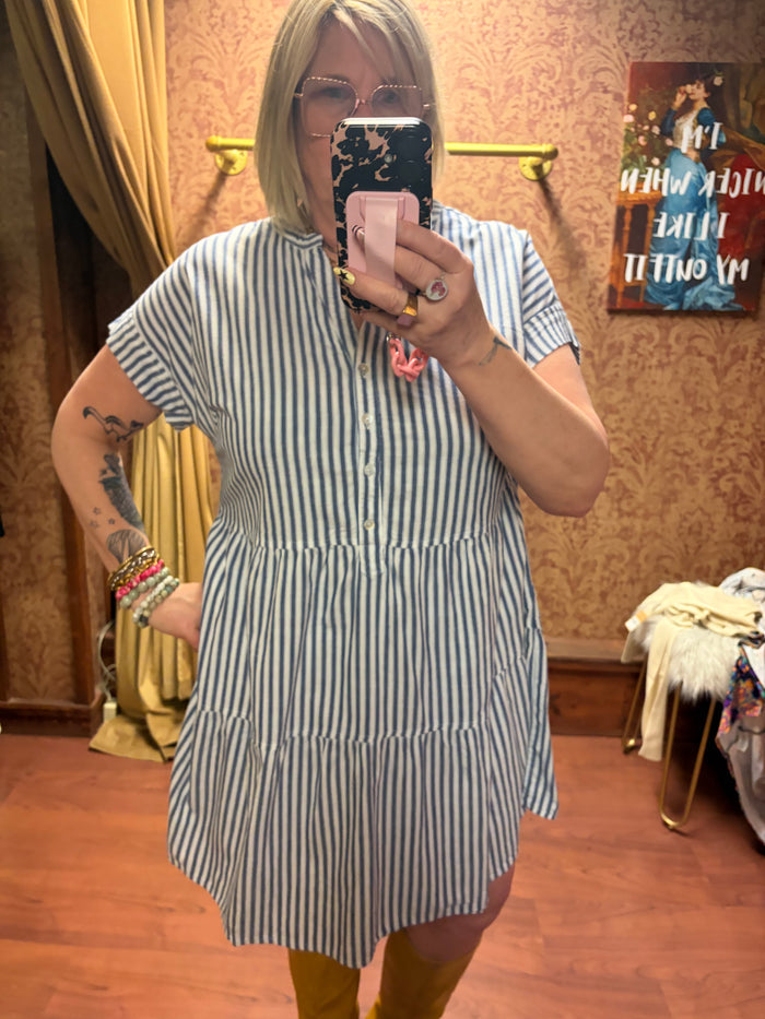 Camille & Co. striped ticking dress with a fitted bodice and flowing skirt, featuring classic blue and white vertical stripes.