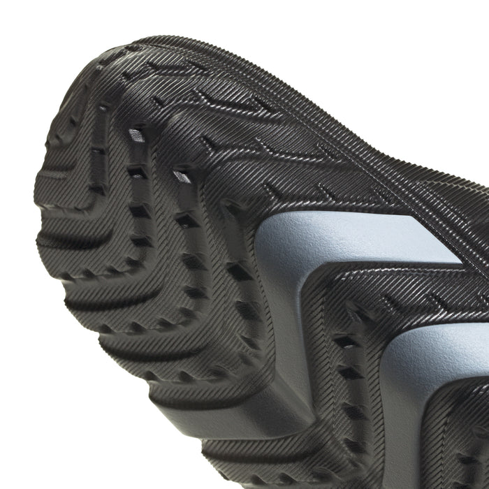 Close-up of men's black slide sandal tread and light-colored side stripe