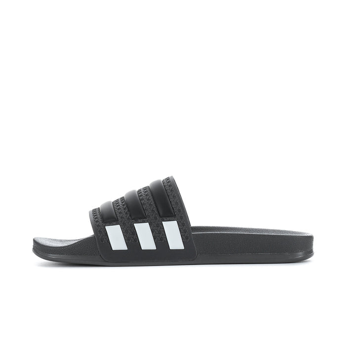 Men's black slide sandals with white triple stripes in a side profile