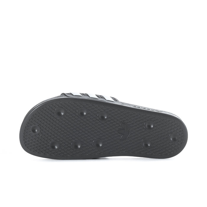 Black rubber outsole with grip nubs and textured tread pattern