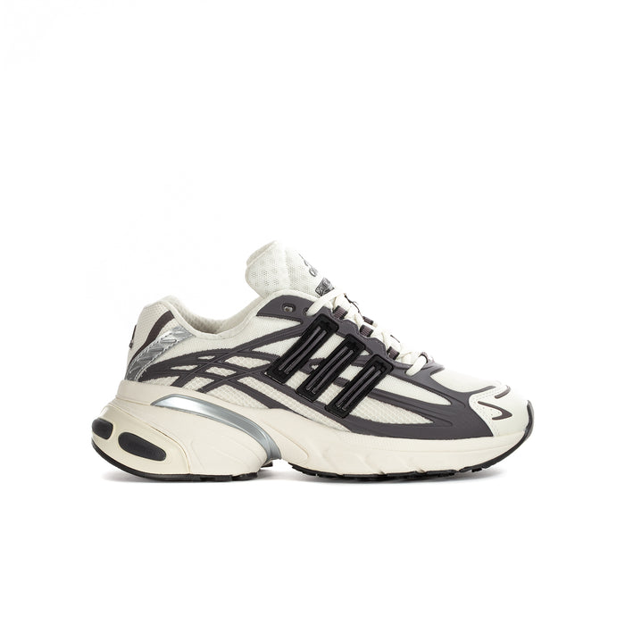 Youth adidas sneakers in cream and black, lace-up with bold side stripes.