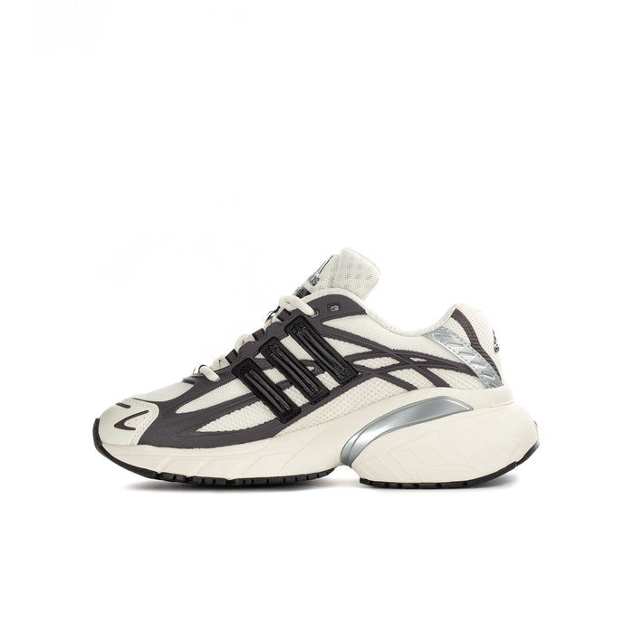 Youth adidas sneakers side view with cream upper, black stripes, and light outsole.