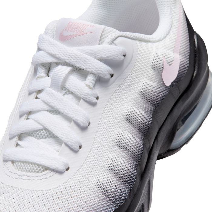 Close-up of youth sneakers, white knit upper with pink swoosh and white laces