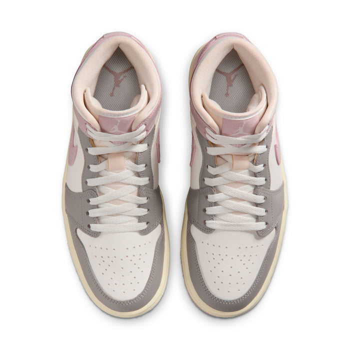 Pair of womens mid-top sneakers showing toe box and lace eyelets in white and lavender