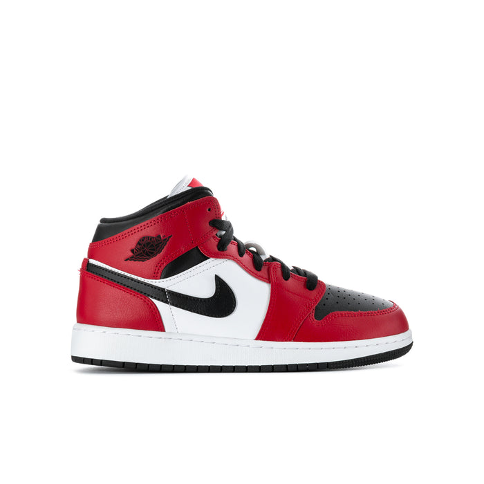 Youth mid-top sneakers in red, black, and white with Nike swoosh and lace-up design
