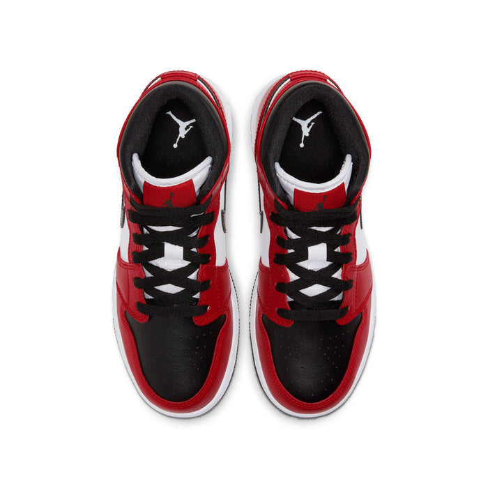 Youth sneakers with black toe areas, red uppers, lace-up tops, and interior branding