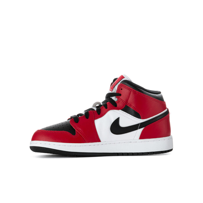 Youth mid-top sneakers with red and black uppers, white swoosh panel, and lace-up closure