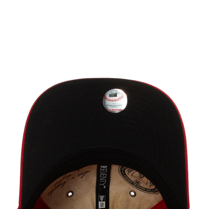 Black baseball cap with embroidered baseball logo on front panel and snapback brim