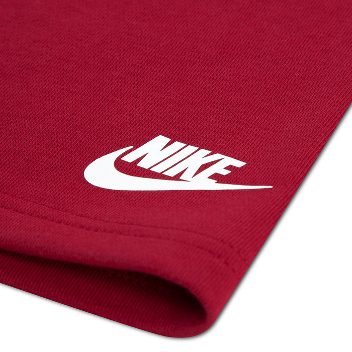 Red french terry shorts fabric close-up with white Nike swoosh logo