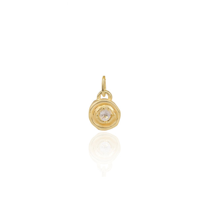 Gold pendant with a central gemstone on a white background