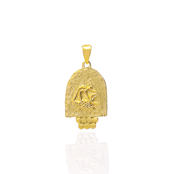 A gold pendant featuring an engraved design on a white background.