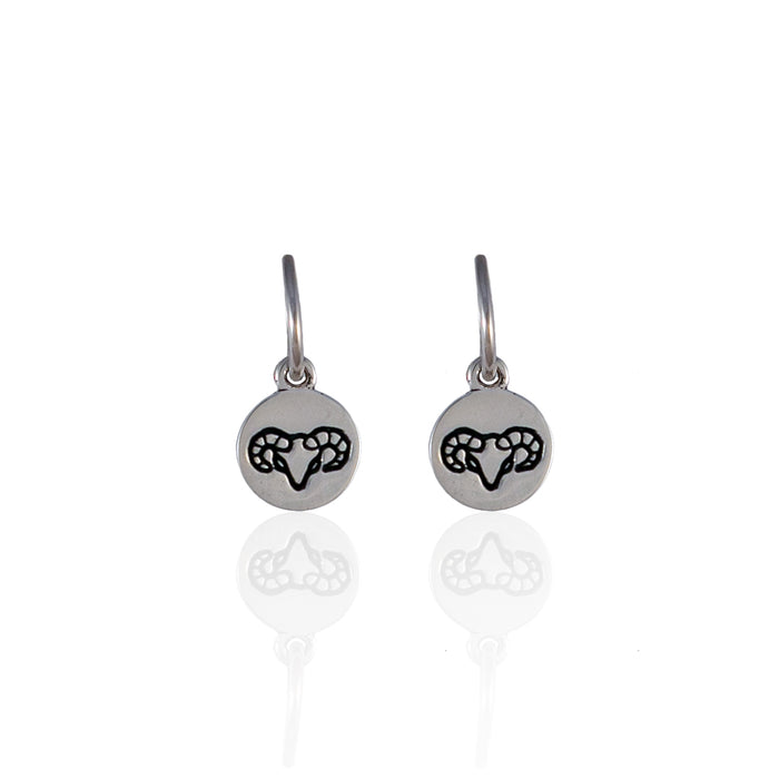 Small round silver earrings with a minimalistic geometric design and white background