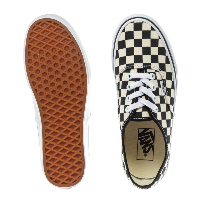 Youth checkerboard canvas sneakers showing tread outsole and Vans logo on tongue