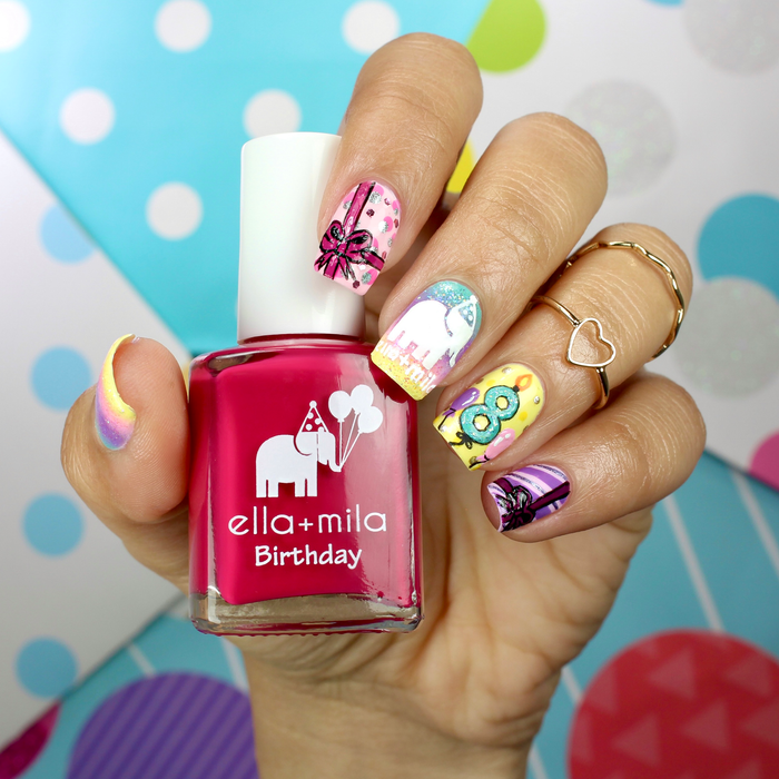 Birthday Collection raspberry manicure with confetti glitter accent nails, holding the bottle