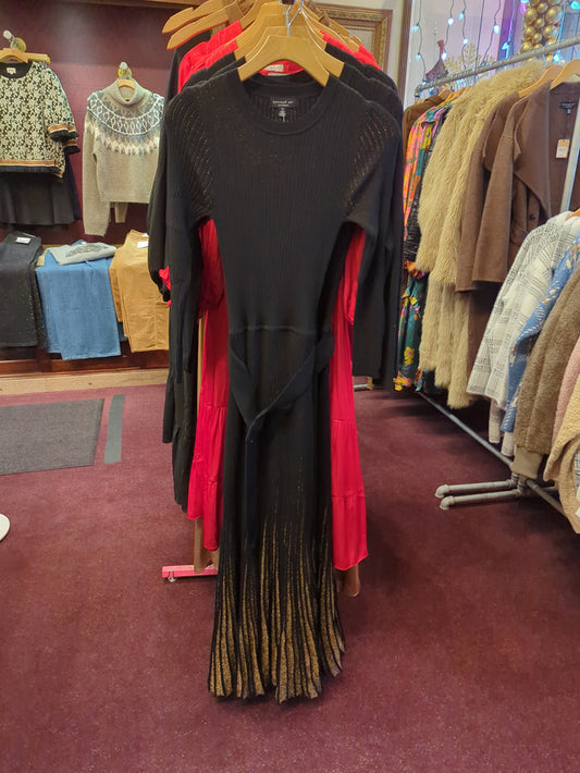 Current Air black gold sweater dress with long sleeves and a fitted silhouette, shown on a model.