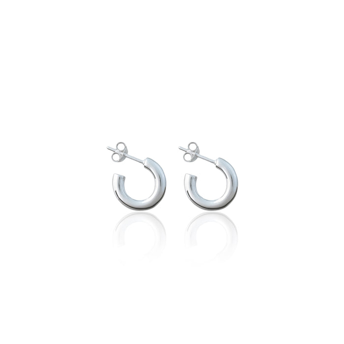 A pair of small silver hoop earrings with post backs against a white background.