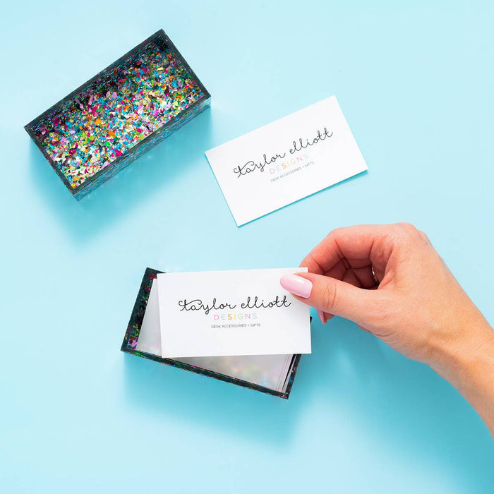 Colorful confetti Taylor Elliott Designs business card holder with vibrant confetti pattern on a sleek metal surface.