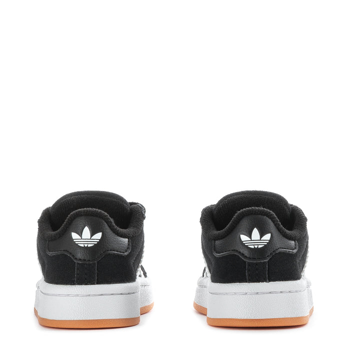Toddler black sneakers with white trefoil logo on heel and gum sole