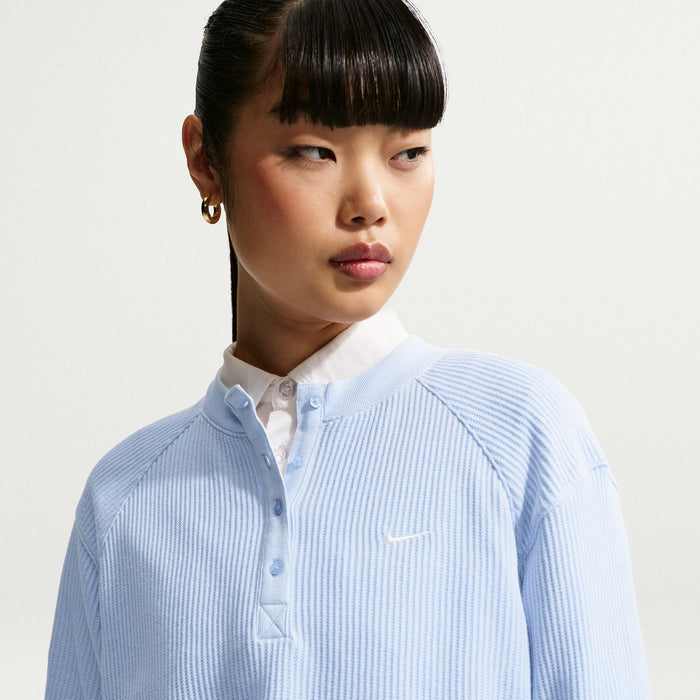 Women’s light blue long-sleeve knit henley top with button placket and small chest logo
