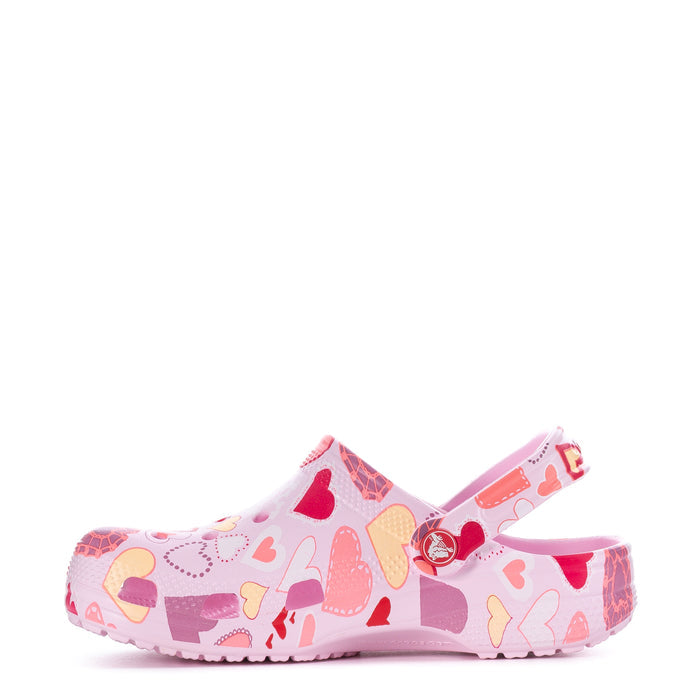 Youth pink slip-on clog with heart print and adjustable strap detail