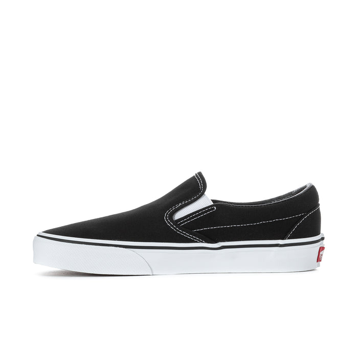 Black slip-on sneakers with contrast stitching and white interior tongue logo