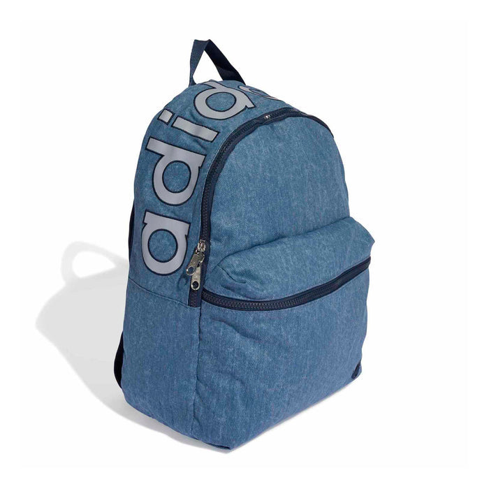 Light denim backpack angled view with front zipper, curved top, and large side logo