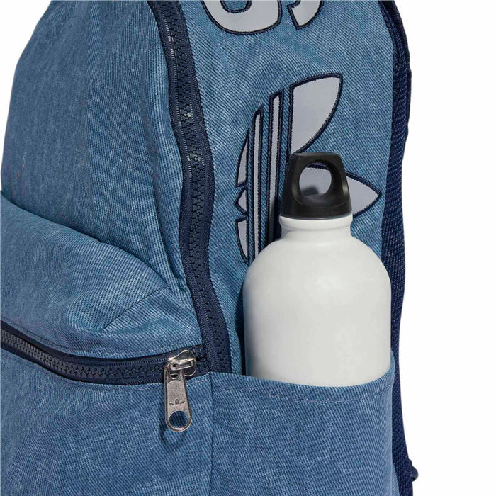 Light denim backpack front pocket with visible water bottle and zipper