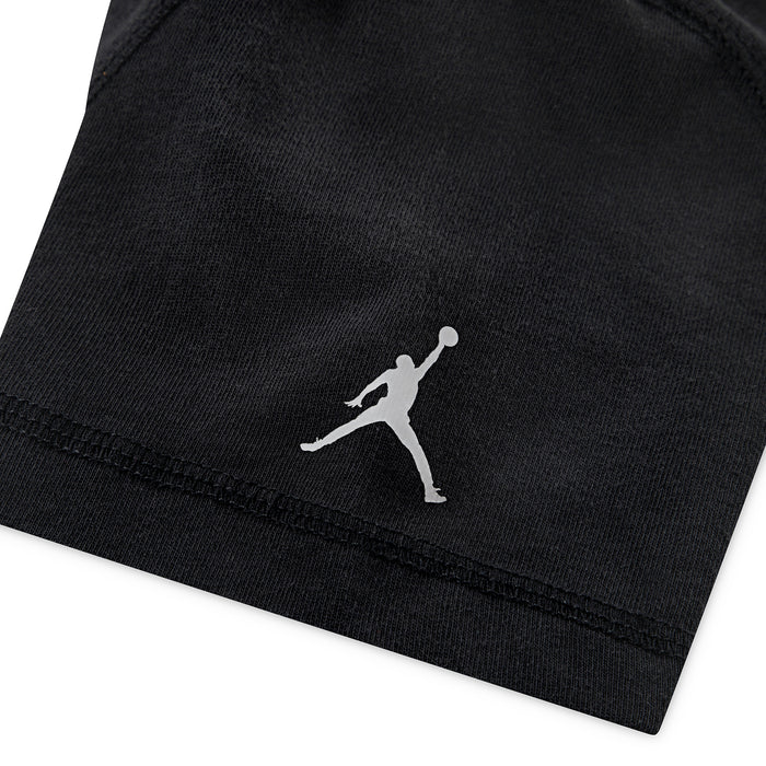 Youth Jordan wash tee sleeve hem detail with small Jumpman logo, dark black.