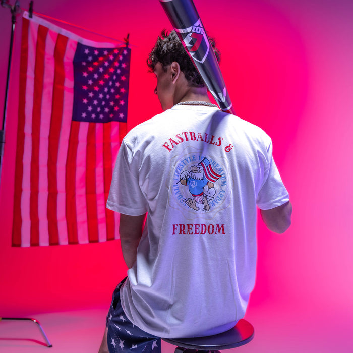 Adult model wearing graphic tee with “Fastballs & Freedom” design