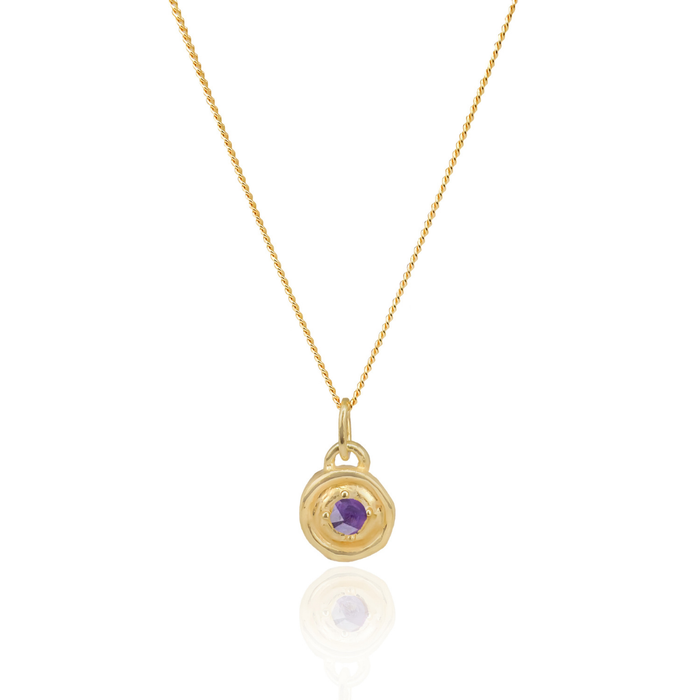 Gold necklace with a purple gemstone pendant on a white background