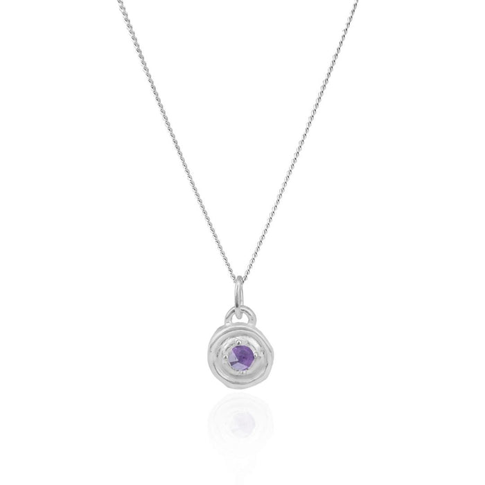 Silver necklace with a round pendant featuring a purple gemstone on a white background