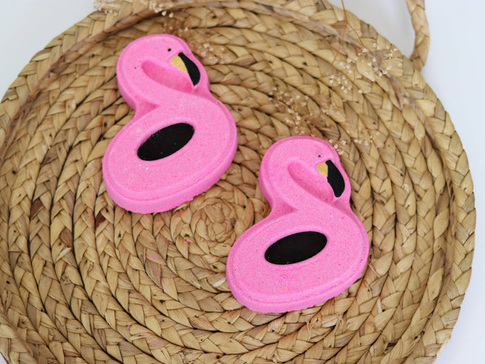 Pink flamingo-shaped bath bomb from Sudsy Soap Works LLC, designed for relaxing bath time with colorful, playful appearance.