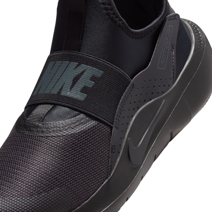 Youth black sneaker close-up of side strap with teal Nike logo