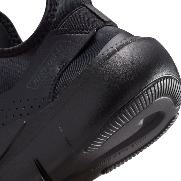 Youth black sneaker close-up of heel area and ribbed traction sole