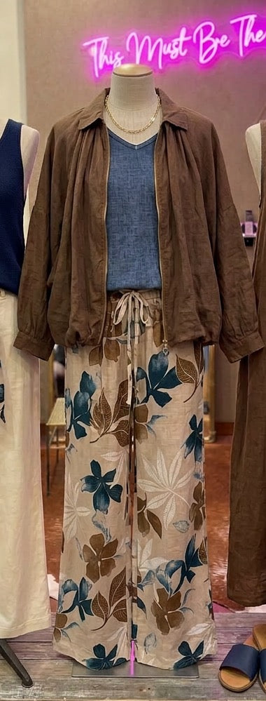 Camille & Co. flowered linen pants with a relaxed fit, featuring a vibrant floral pattern and lightweight, breathable fabric.