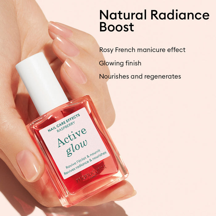 A hand holds a pink bottle of French Manicure Glow by Manucurist. Text: Natural Radiance Boost. Rosy French manicure effect, gel-like shine, glowing finish, nourishes and regenerates nails.