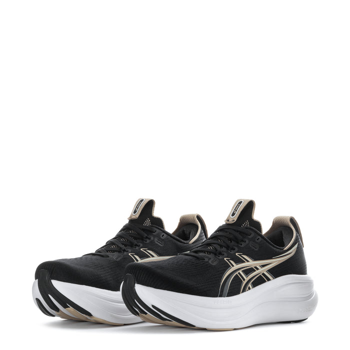 Pair of women’s black running shoes with gold stripe accents and white midsole