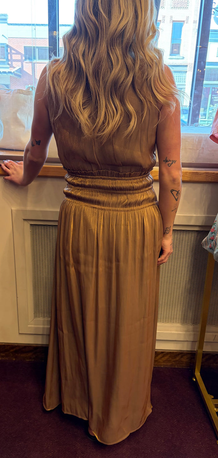 Golden silk halter dress by Current Air, elegant dress with flowing fabric and halter neckline, displayed on a mannequin.