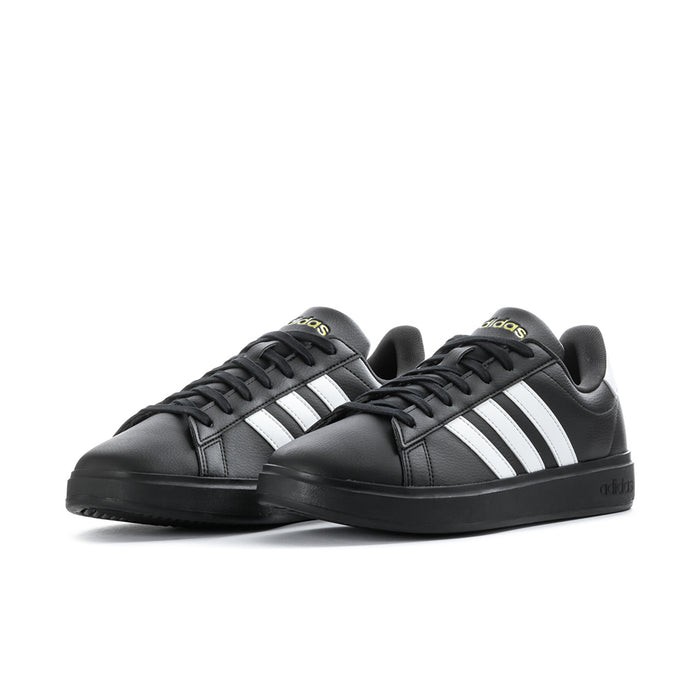 Pair of men's black low-top sneakers with white triple stripes and black laces
