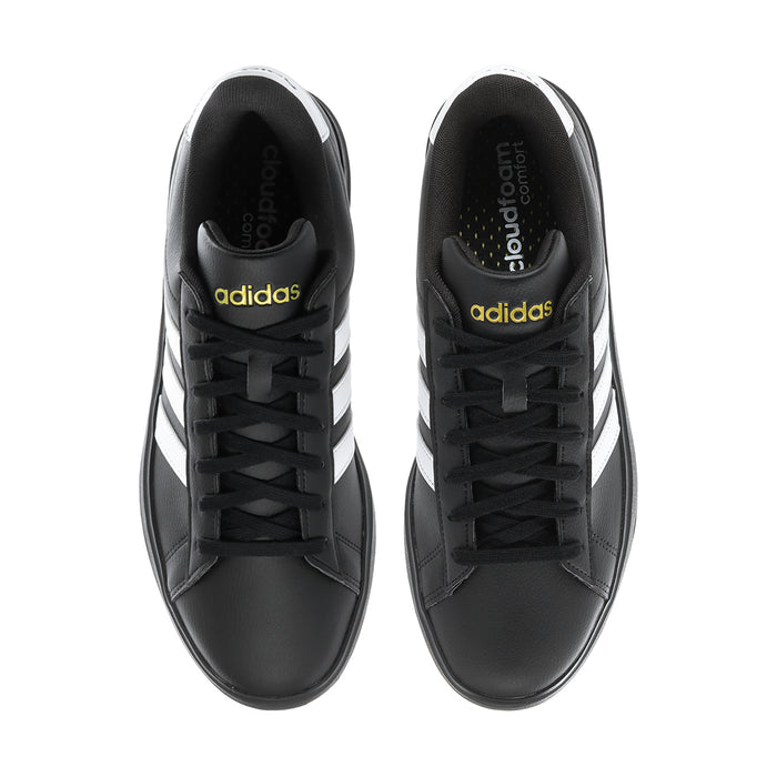 Men's black sneakers with black laces and adidas branding on heel tabs