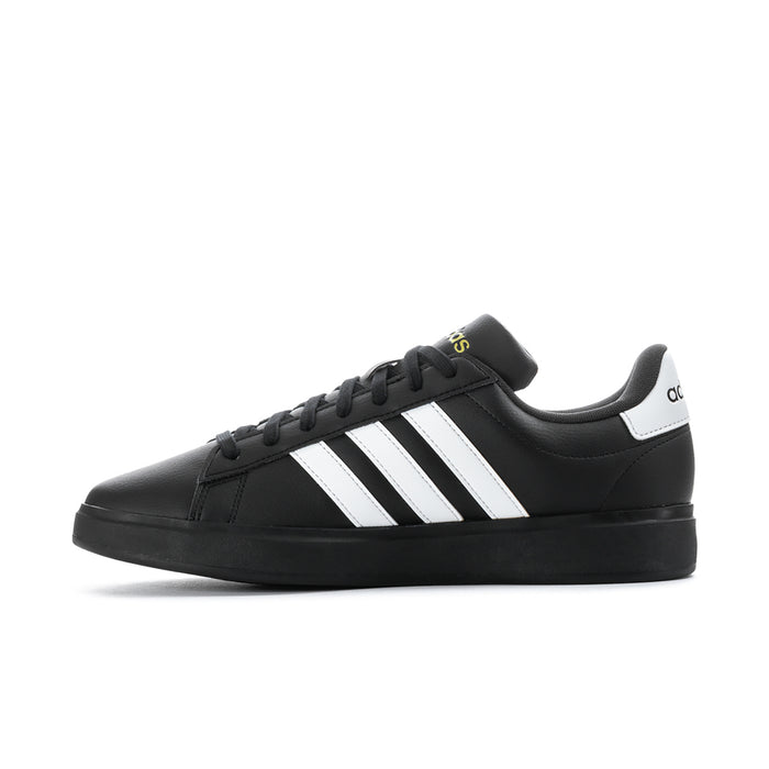 Men's black low-top sneakers with white triple stripes and padded collar