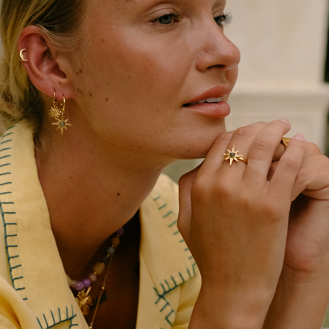 Golden hour lighting on a woman wearing gold jewelry