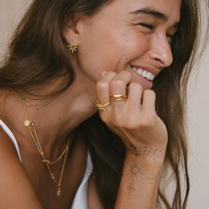 Luna & Rose x Tahnee Kelland ‘I Told You About the Stars’ gold earrings, matching star design with labradorite accents, handmade in Bali with model laughing.